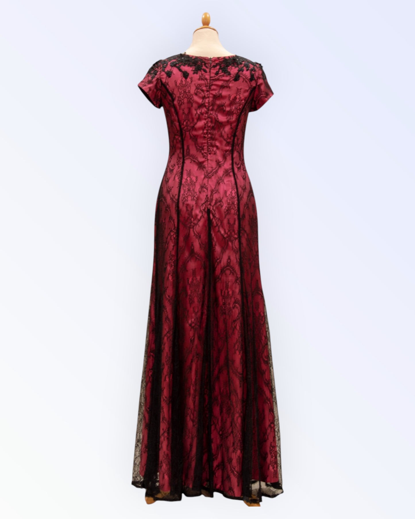 Long formal dress made of black lace with bright pink lining