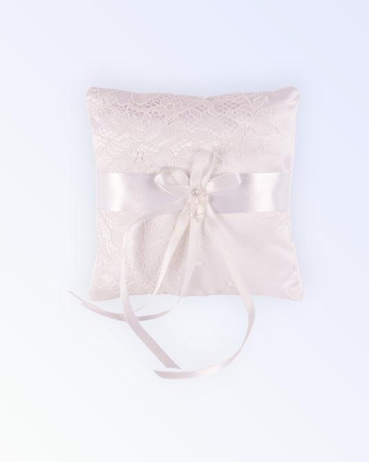 White satin ring pillow covered with thin lace