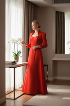 Ageless.ee red satin A-line evening gown with delicate straps and beaded belt, worn by a model indoors.