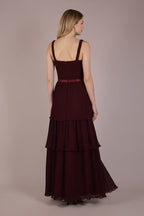 Ageless.ee deep burgundy tiered pleated maxi dress with embellished bodice, velvet waistband, and flowing skirt.