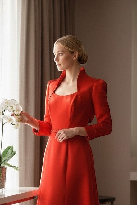 Ageless.ee - woman in a red satin dress and matching bolero jacket with a jeweled belt.