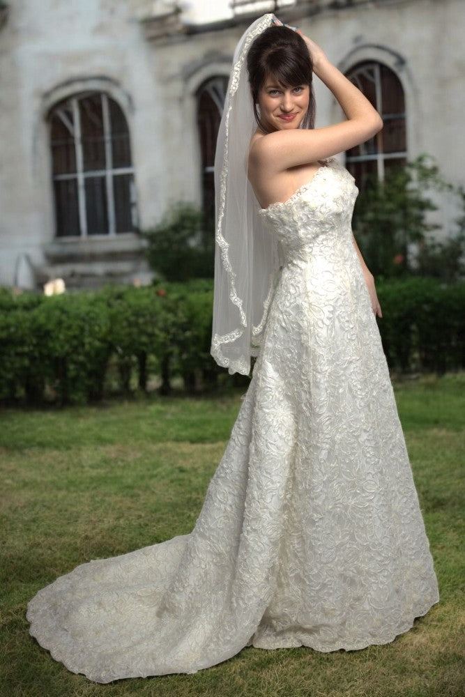 Off-white lace wedding dress with train