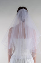 Kahekordne kellukesekujuline masinaga ääristatud pruudiloor