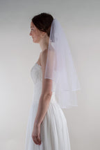 Kahekordne kellukesekujuline masinaga ääristatud pruudiloor